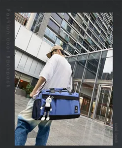 Large capacity blue travel duffel bag gym sports bag with cute pendant for men daily use.