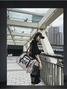 Detail view of large capacity travel gym bag in urban outdoor scene, showing sturdy straps.