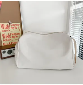 Large capacity minimalist white yoga fitness bag and travel duffel with adjustable strap.