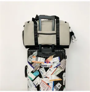 Detailed view of the large capacity travel duffel bag with trolley sleeve in light gray design.