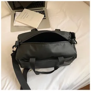 Black waterproof sports gym duffel bag with shoulder strap for travel and fitness use.