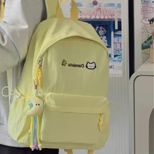 Cute Japanese style yellow canvas casual backpack detail view with sweet cat embroidery and pendant