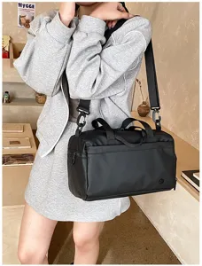 Detailed view of black waterproof gym duffel bag with shoulder strap, ideal for travel.
