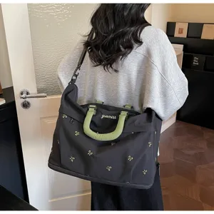 Large capacity travel duffel bag with green handles and embroidery for short trips and fitness use.