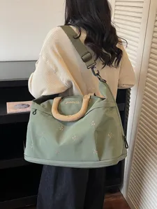 Large capacity expandable travel duffel bag with bow embroidery for short trips and fitness.