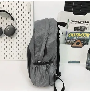 Grey waterproof backpack side detail view, lightweight outdoor travel school book bag.