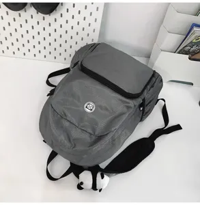 Gray casual travel backpack detail view, lightweight waterproof outdoor daypack with cute pendant.