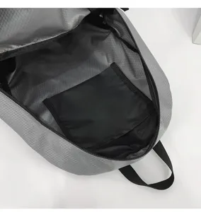Interior detail of waterproof gray backpack with inner pocket and secure zipper closure.
