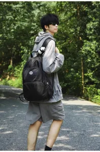 Outdoor travel backpack detail showing large capacity and durable black fabric material.