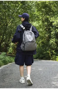 Detailed view of grey waterproof outdoor travel backpack in forest outdoor setting scene use.
