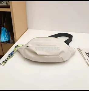 Casual white crescent sling bag with black strap and stylish printed logo detail for daily use.