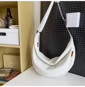 Detailed view of the white crescent shoulder bag, casual dumpling crossbody design, daily use.