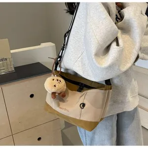 Retro casual canvas crossbody bag for women, stylish niche design messenger bag with details.