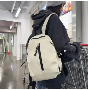 Detailed view of the casual canvas backpack showing its minimalist design and convenient front pocket.