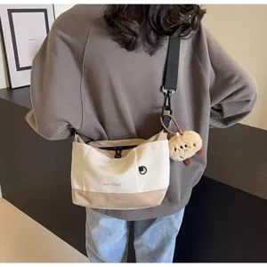 Vintage casual canvas crossbody bag for women, stylish contrast color messenger shoulder bag.