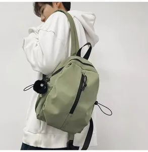 Lightweight casual backpack for men and women, stylish green school bag with convenient zipper pockets.