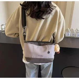 Retro casual women's canvas crossbody bag, stylish niche design messenger bag for daily use.