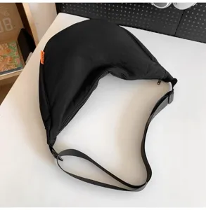 Casual black cross body bag for women and men, large capacity crescent sling backpack daily use.