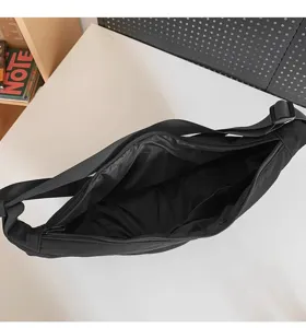 Black large capacity crossbody shoulder bag, solid color casual dumpling bag interior detail.