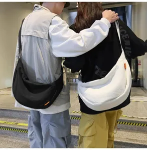 Detailed view of couple street style canvas crossbody bag, casual large capacity design.