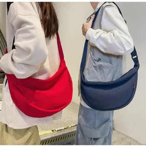 Detailed view of the large capacity casual crossbody dumpling bag showing wearing style.