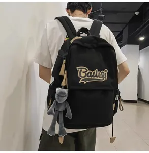 Casual black canvas backpack for students, large capacity school bag with cute plush pendant.
