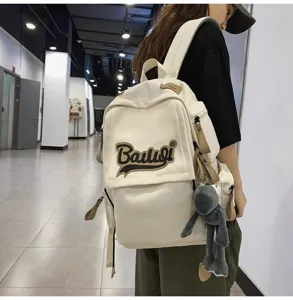 Casual canvas backpack in off-white with contrast brown trim and stylish embroidered details.