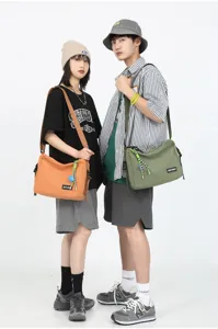 Detail shot of Japanese workwear canvas messenger bag, showing casual crossbody style.