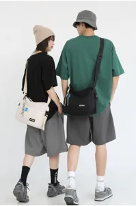 Japanese solid color canvas messenger bag, minimalist casual crossbody bag for men and women students.