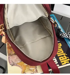 Red canvas chest bag detail interior compartment view, casual crossbody backpack for travel.