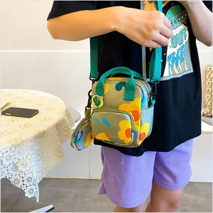 Casual canvas crossbody bag with floral pattern, small handbag for daily wear and trendy style.