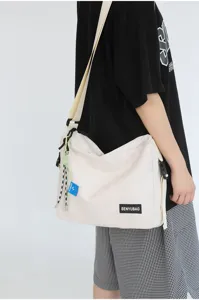 Japanese solid color canvas messenger bag casual crossbody bag for women and men daily commute.