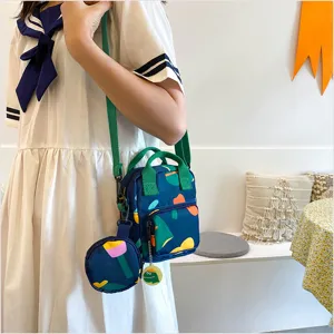 Close-up detail of the Japanese style canvas crossbody handbag with colorful geometric print and cute green straps.