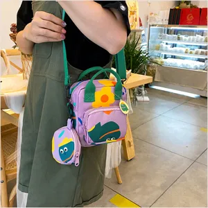 Cute canvas crossbody bag with funny cartoon prints, green handles and coin pouch.