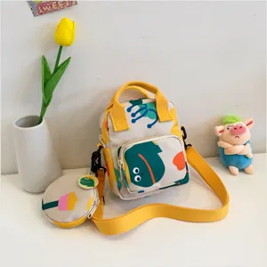 Detailed view of trendy Japanese sweet canvas crossbody bag with cute cartoon print and coin pouch.