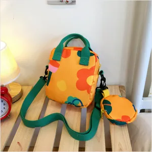 Japanese style cute floral canvas crossbody bag with green handle and small coin purse detailed.