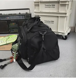 Detail view of the large capacity black travel duffel gym bag with side mesh pockets and shoulder strap.