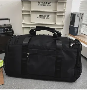 Black travel duffel bag detail showing durable fabric, sturdy handles and smooth zippers.