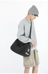 Large capacity black travel gym duffel bag with shoulder strap and side pocket detail.