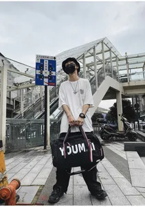Large capacity travel duffel bag shown in urban use, durable gym and fitness storage bag.
