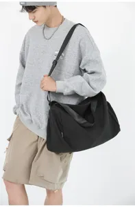 Large capacity black duffel bag travel fitness shoulder bag for men and women daily use.
