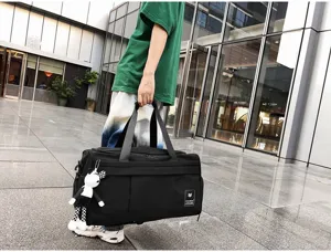 Detailed close-up view of large capacity black travel gym bag for sports and short trips.