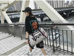 Detail view of large capacity travel duffel bag with shoulder strap and stylish print.