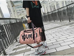 Outdoor scene detail showing the pink travel gym bag with large capacity and straps.