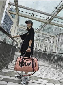 Large capacity travel duffel bag for fitness and short trips, stylish pink design with handles.