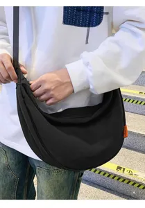 Black canvas crossbody dumpling bag for women and men, casual large capacity design.