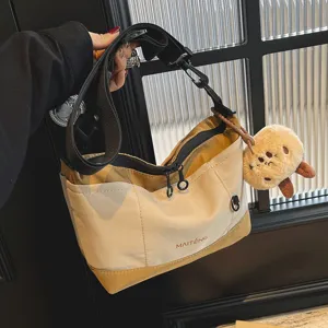 Vintage casual canvas crossbody bag for women, stylish daily shoulder bag with plush charm.