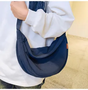Detail view of the large capacity navy blue crescent crossbody bag, casual and lightweight.