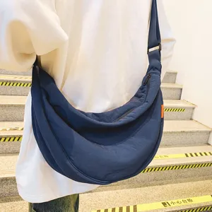 Large capacity nylon crossbody bag for women and men, casual solid color crescent bag.