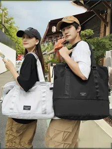 Detailed lifestyle view of large capacity travel duffel bags carried by models outdoors.